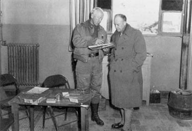 General Patton (left) confers with General Eisenhower at the beginning of the II Corps offensive.
