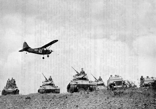 Photo:  The primary vehicles used by the Constabulary. From left to right: M8 armored car; M24 light tank (Chaffee); Willys 1/4-ton jeep. Overhead flys an L-5 Sentinel Observation aircraft. 1946.