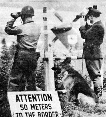 Photo: A US soldier and a member of the German Customs Police peer across the border just inside the 50-meter restricted zone. Circa 196