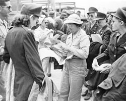 Lieut. Colonel Nola G. Forrest, 
	   Director of Nursing in the SWPA, distributes orders to the liberated Army Nurses