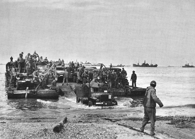 Photo:  Rhino ferry discharging men and supplies on a Normandy beach
