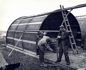 Photograph, Men in Ireland construct a steel hut