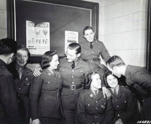 Photograph, American soldiers and Irish girls have a friendly chat during the Saint Patricks Day Dance and Celebration